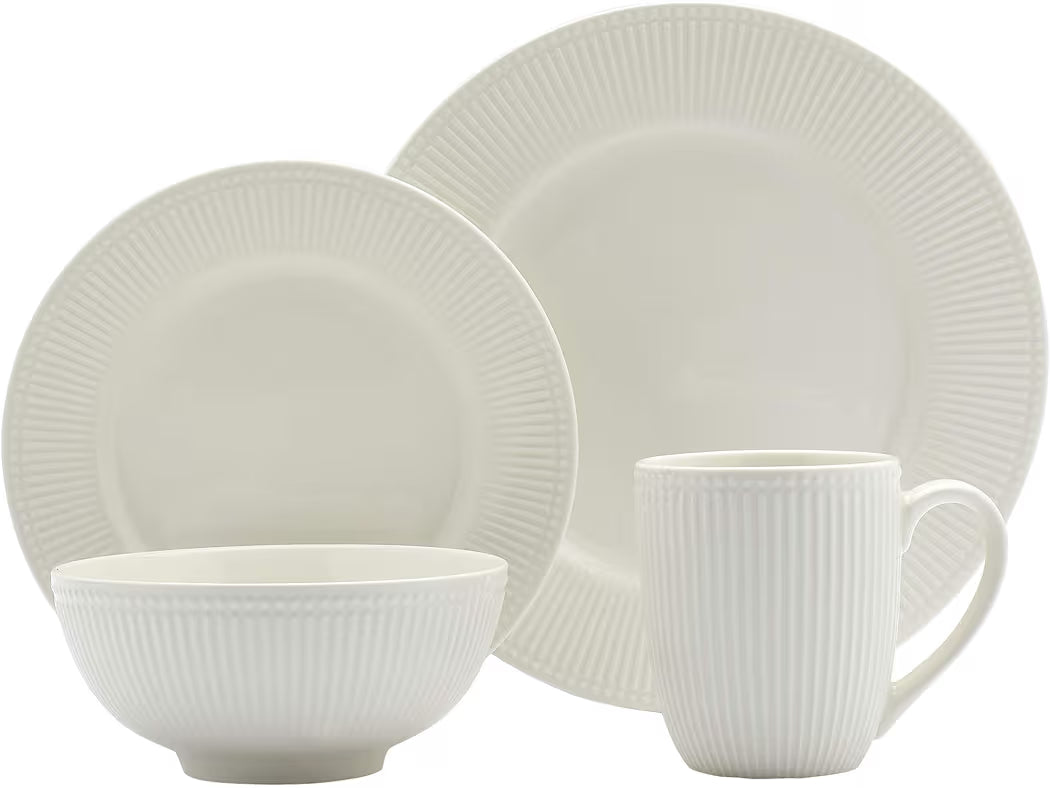Modern white ceramic dinnerware set with plates and bowls in a minimal design